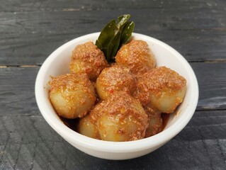Indonesian food cilok bumbu kacang is a food made from flour and sago with peanut sauce on the wooden table