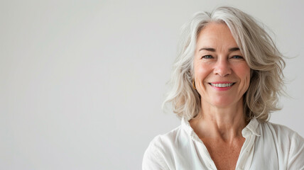 Fototapeta premium senior woman smiling and looking at the camera on a white background