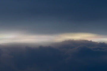A cloudy sky with a few clouds in the distance