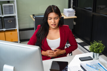 Tired asian businesswoman with headache at office, feeling sick and Chest pain, Woman feeling sick.