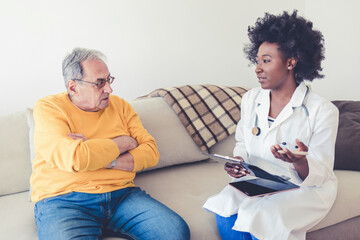 Senior, man and caregiver with tablet for consultation with coughing, chest pain and pneumonia symptoms. Elderly patient, nurse and discussion in nursing home, medical diagnosis or healthcare on sofa.