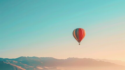 Fototapeta premium A single hot air balloon floats in a serene sky above rolling hills, capturing the beauty of a peaceful morning.