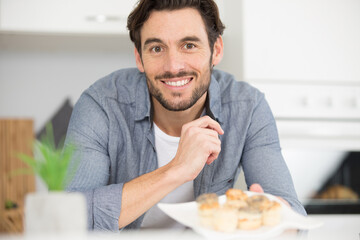 portrait of man with a plate of canapes