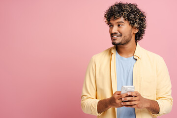 Happy young adult man using smartphone browsing social media