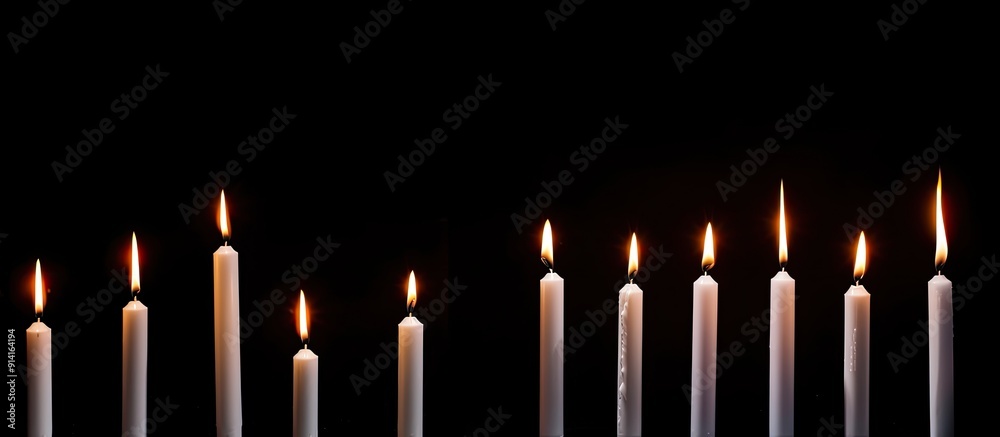 Aufkleber Various sizes of white candles burning on a black background creating a tranquil ambiance with copy space for an image