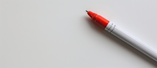 Fototapeta premium Marker with an eraser and magnet on a white backdrop with copy space image