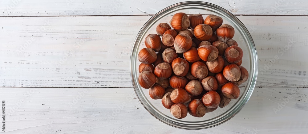 Aufkleber hazelnuts without shells in a glass bowl on a white wooden surface exemplifying healthy eating with 