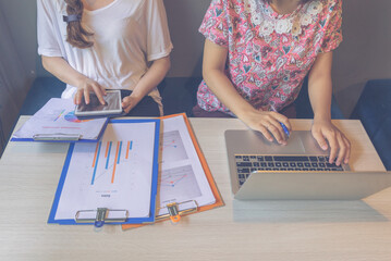 Close-up photo of women hands using laptop tablet while working