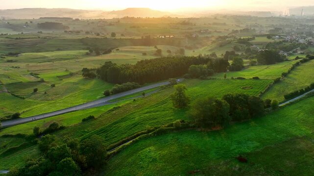 drone view of foggy sunrise in Galicia, idyllic aerial view of the fields in the north of Spain, tourism in Galicia, tranquil countryside, Camino de Santiago in Spain