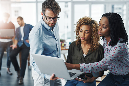 Business people, website and laptop for project in office, team helping and advice or support. Staff, public relations agency and review discussion on press release, report and publicity coverage