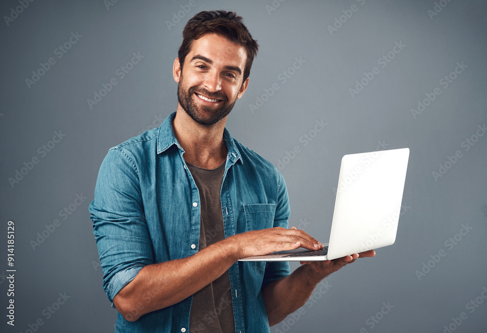 Aufkleber Laptop, happy and portrait of man in studio with research for creative software with project development. Smile, technology and graphic designer work on multimedia art on computer by gray background.