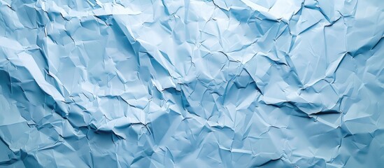 Obraz premium Light blue crumpled paper texture ideal for a copy space image