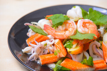 Spicy mixed seafood salad on the white background.