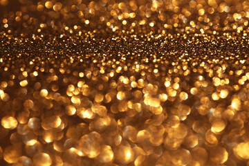 Golden glitter festive bokeh background, abstract defocused texture. Holiday lights