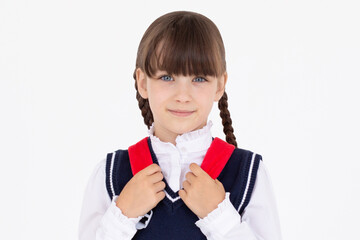 Indoor picture of young good-looking teenage girl isolated on white background in school uniform,...