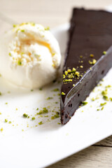 Chocolate cake brownie with ice cream and pistachio on white background
