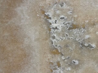 Marble Tile texture closeup as an abstract background. Natural Honed stone slab. Details of matte ceramic wall or floor. Gray surface with satin finish and a pattern of random irregular white spots.