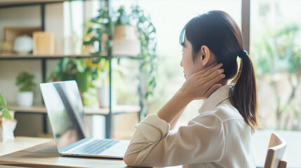Fototapeta premium Asian businesswoman sitting with neck pain while working using a computer