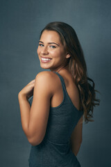 Naklejka premium Happy, hair and portrait of woman in studio with healthy texture for wellness, salon and growth. Haircare, attractive and face of isolated person with confidence, beauty and pride on gray background