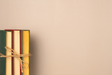 Stack of books on a beige background. Leisure concept, reading a book. Copy space. Flat lay, top...