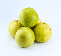 five half ripe red guavas on a white isolated background