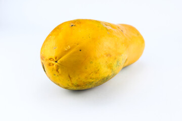 Ripe papaya fruit with a fresh looking light orange color on a white isolated background