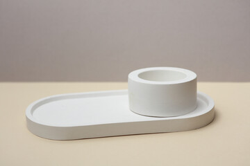 Decorative plaster trays on beige background. Stands for candles, organizers for cosmetics or jewelry.