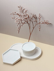 Decorative plaster trays with dry flowers on beige background. Stands for candles, organizers for cosmetics or jewelry. Creative showcase