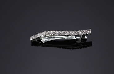 Hairpin with precious stones on a black background