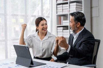 A woman and a man are smiling and celebrating together