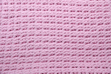 Texture of pink knitted plaid closeup