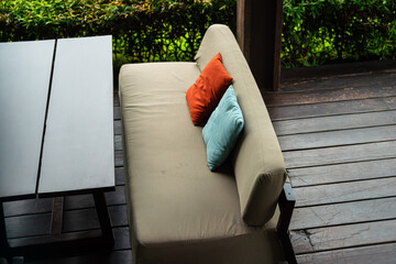 A cozy designed sofa seat with colorful pillow set at hotel lobby. Interior furniture and...