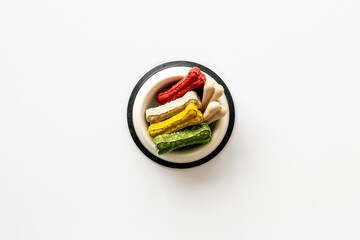 Bowl full of chew bones for dog. Food and treats for pets