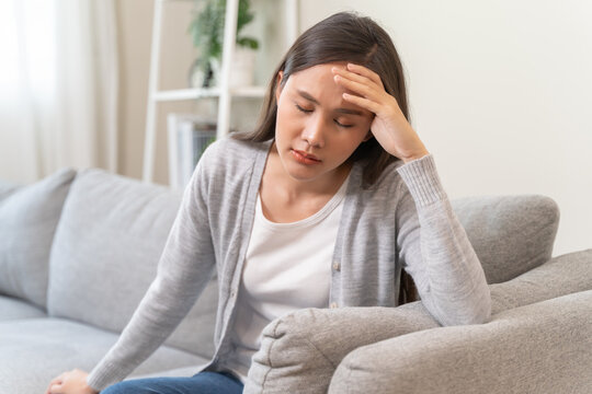 Young Asian females feeling dizzy after standing too fast, have symptoms of low blood pressure