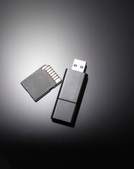 SD memory card with flash drive on black background