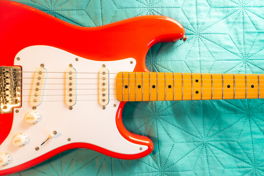 Fiesta Red Squire Stratocaster guitar on a bleu background. S&atilde;o Paulo, Brazil, Juli 27, 2024.