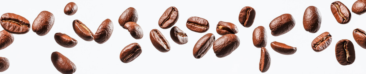 Obraz premium Coffee beans falling on a white background, top view, panorama.