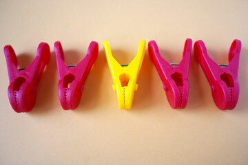 Red and yellow plastic clothes clip on the table.