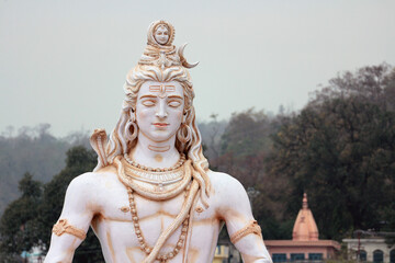 Portrait of Shiva meditating on the banks of the Ganges. Statue in Rishikesh.