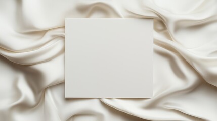 Wedding dress satin cloth around a White blank wedding invitation mockup.