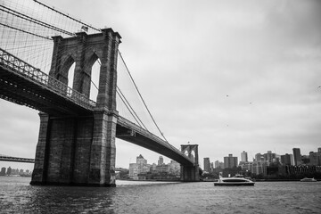 Black and white photograph of the Brooklyn Bridge, the Hudson River, and the Brooklyn neighborhood...