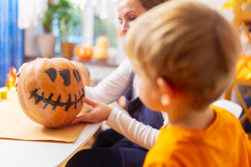 Family Carving Pumpkin for Halloween at Home