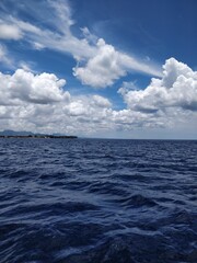 Dark blue sea and light blue sky. Deep blue water.