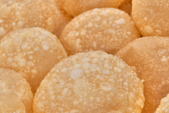 Texture of baursaks of Siberian Tatars, pieces of dough, fried in deep fat.