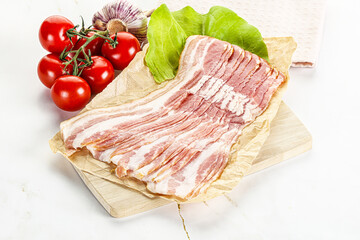Sliced pork bacon oved board