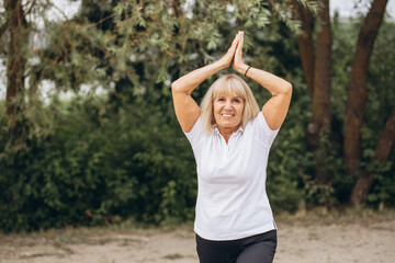 Senior Woman Practicing Yoga Outdoors with a Smile