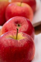 Close up of fresh apples in a bowl on plate on the table, harvest festival