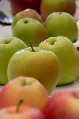 Close up of fresh apples in a bowl on plate on the table, harvest festival