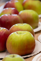 Close up of fresh apples in a bowl on plate on the table, harvest festival