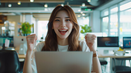 Asian businesswoman sitting in an office with a digital tablet. excitedly raising her hands in celebration, capturing a moment of triumph and joy